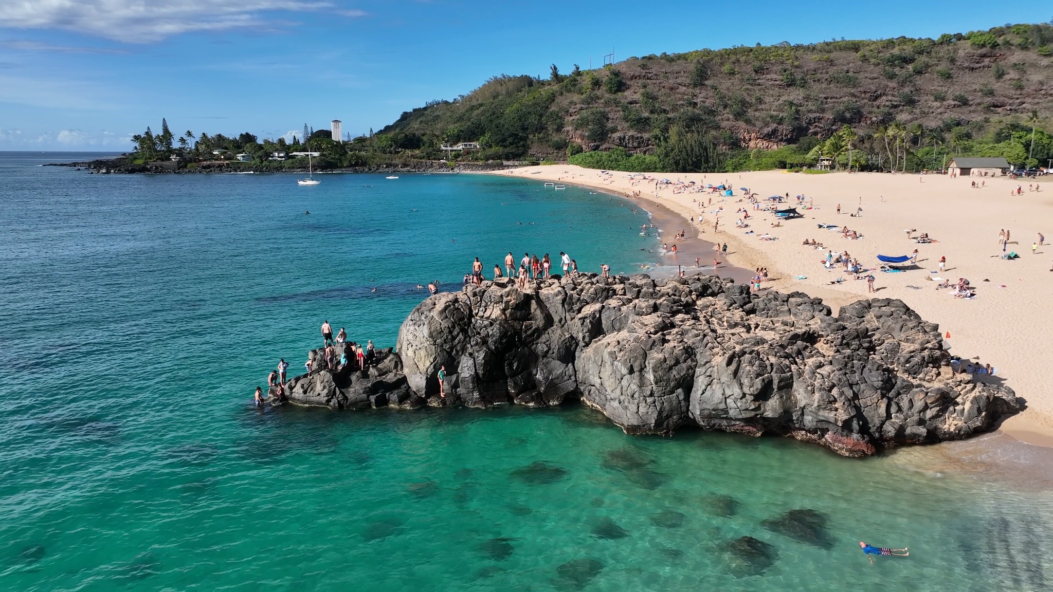 Waimea Bay’s beach and rocky shoreline, Oʻahu.
