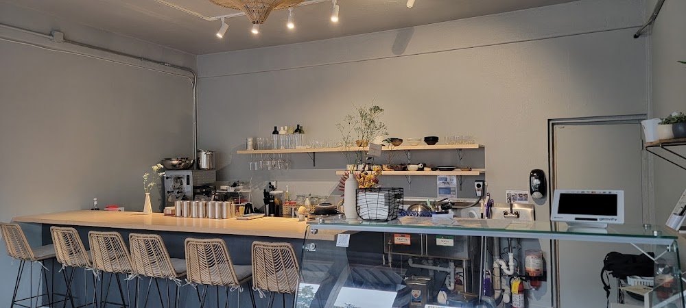Zen Gelato & Bar interior with woven bar stools and a glass display counter