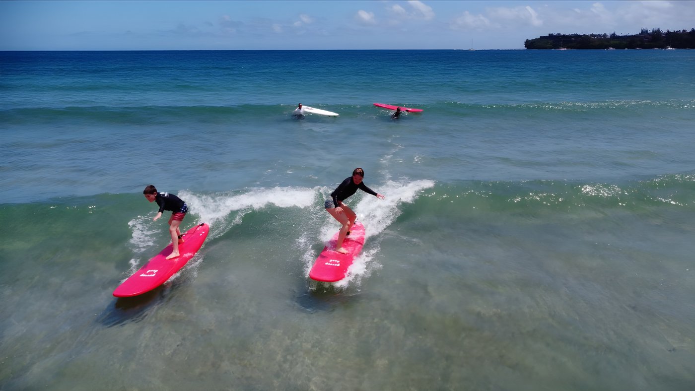 A Hanalei Bay surf lesson pictured on Aloha Surfing School’s official website.