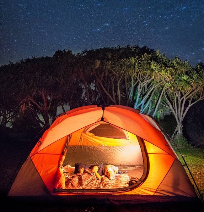 An illuminated tent at Kīpahulu Campground.