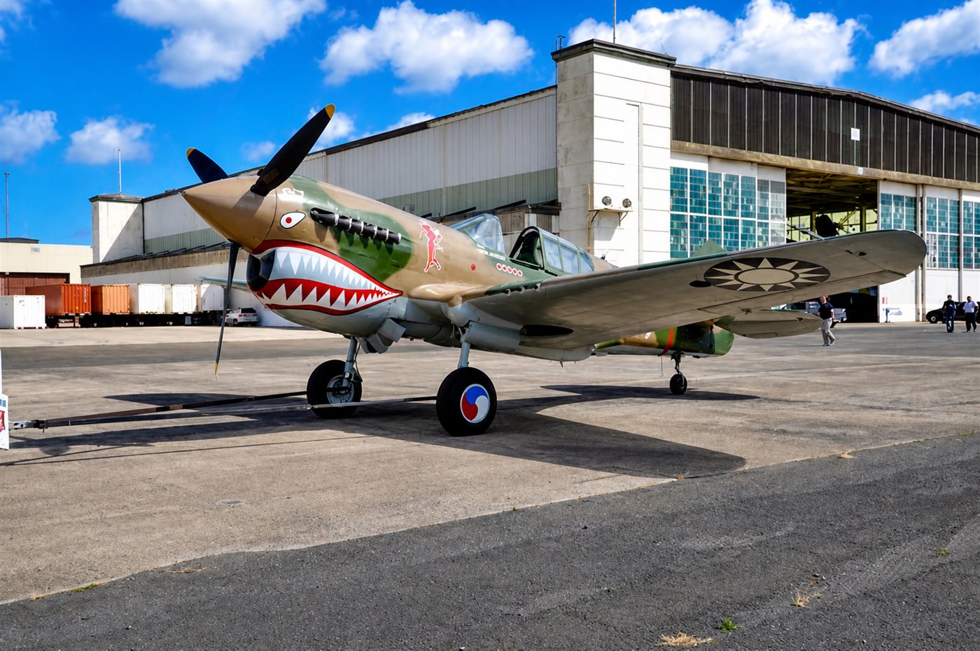 An aircraft outside a hangar at Pearl Harbor Aviation Museum.