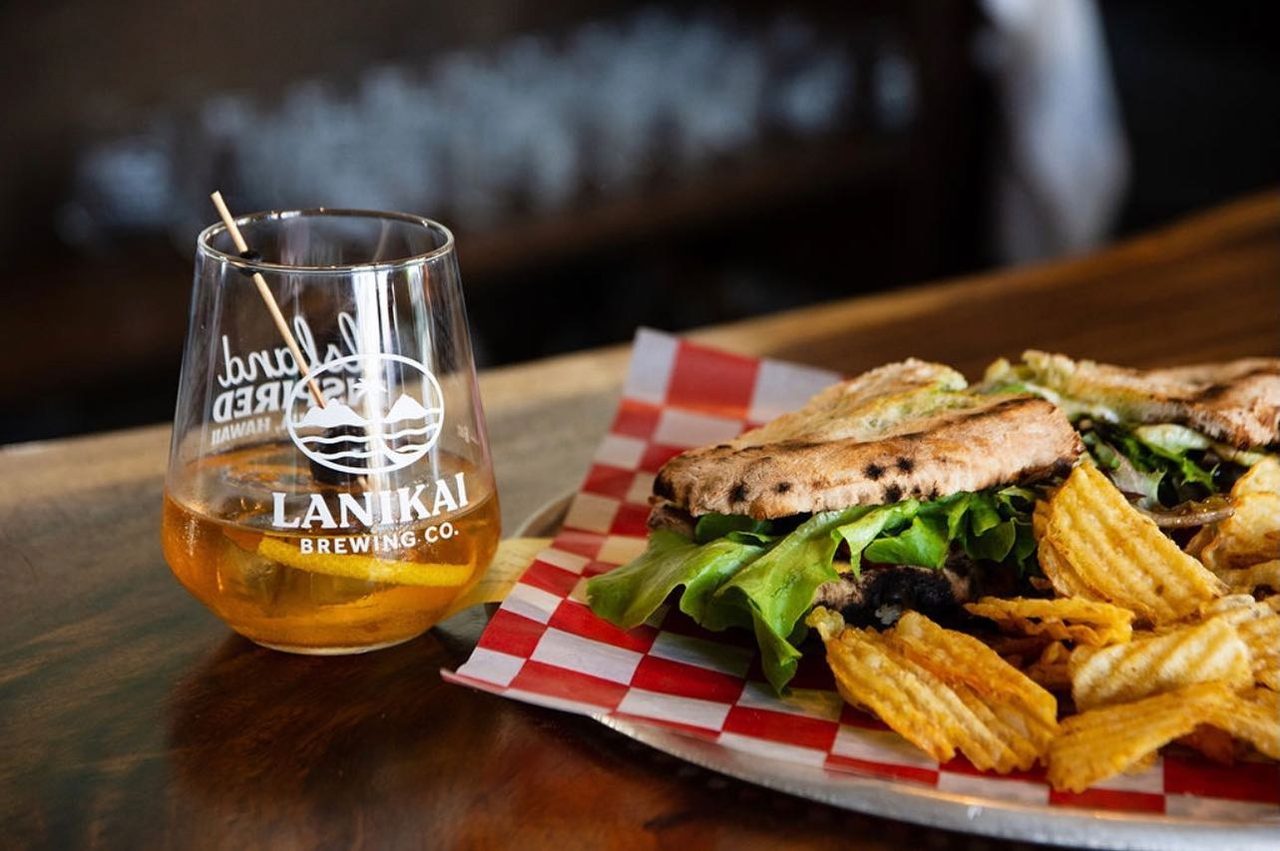Lanikai Brewing beer and sandwich, as featured in the Volcano dining guide; brand-level food photograph