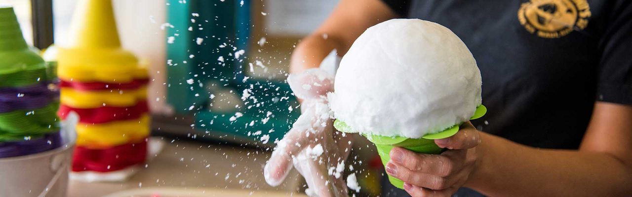 Shaping shave ice at Ululani’s Hawaiian Shave Ice — brand-level food photograph, not Kona-specific