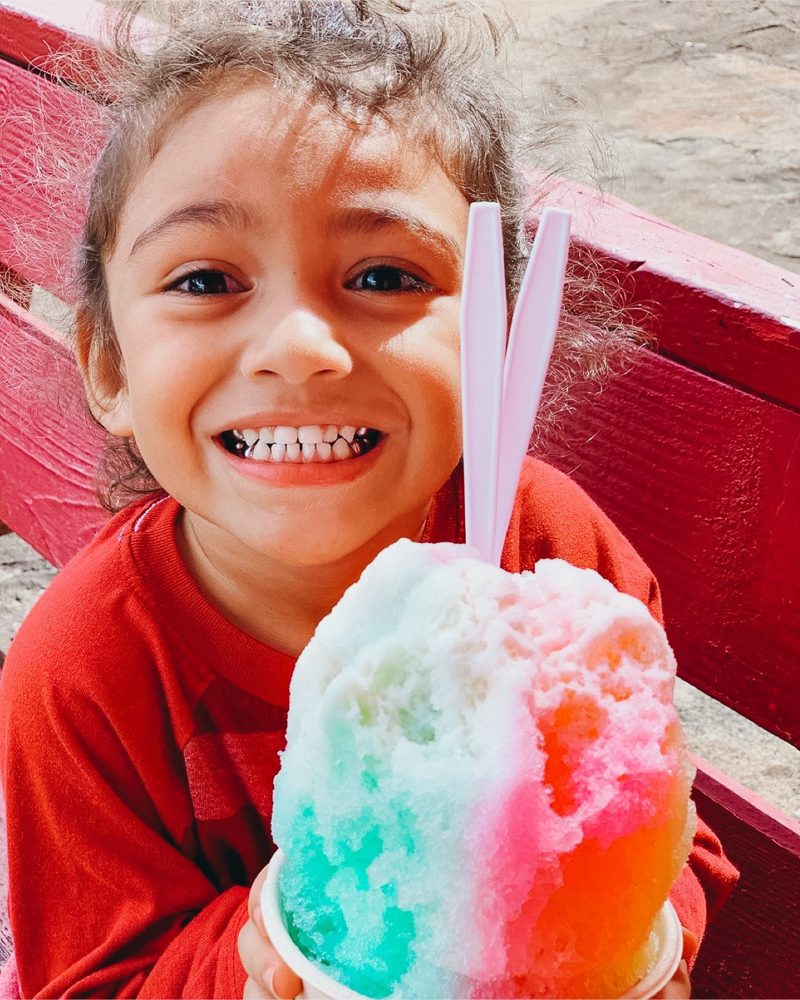 Customer with shave ice — JoJo’s brand photograph; branch not identified