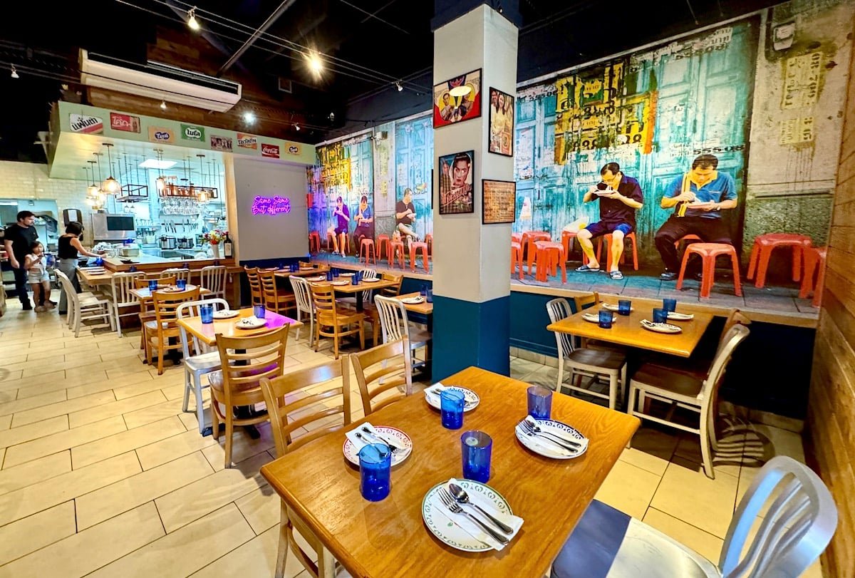 SingSing dining room with colorful street-food mural and blue drinking glasses