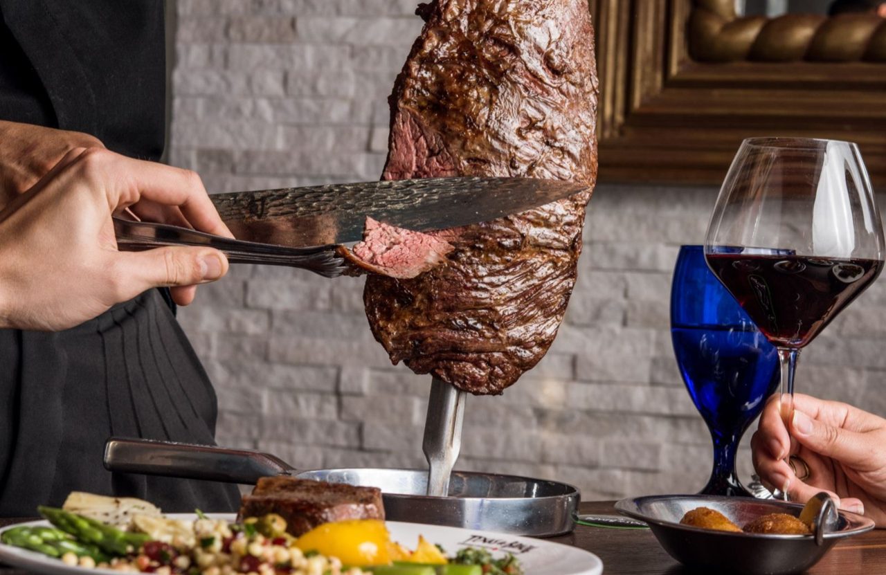 Churrasco carving featured in Texas de Brazil Honolulu listing; brand-level food photo.